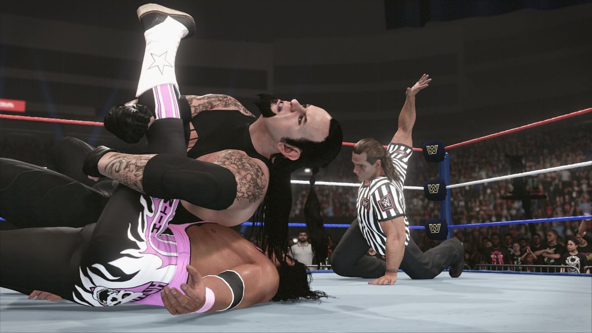 The Undertaker pinning an opponent with HBK as a guest referee in WWE 2K24.