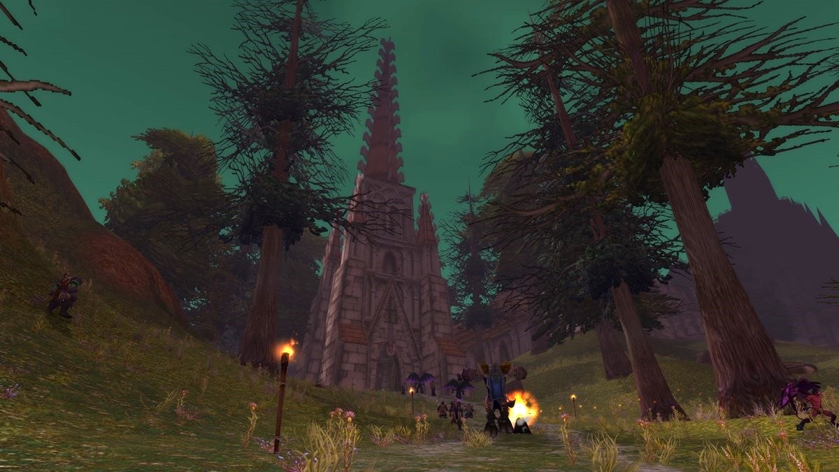 The Scarlet Monastery in WoW with a few players walking towards it