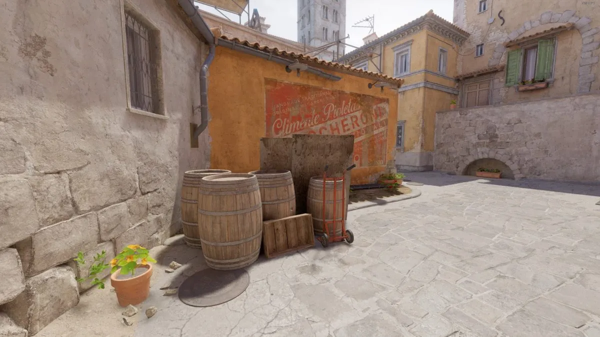 A selection of barrels and plywood at the top of Banana on Inferno in CS2.