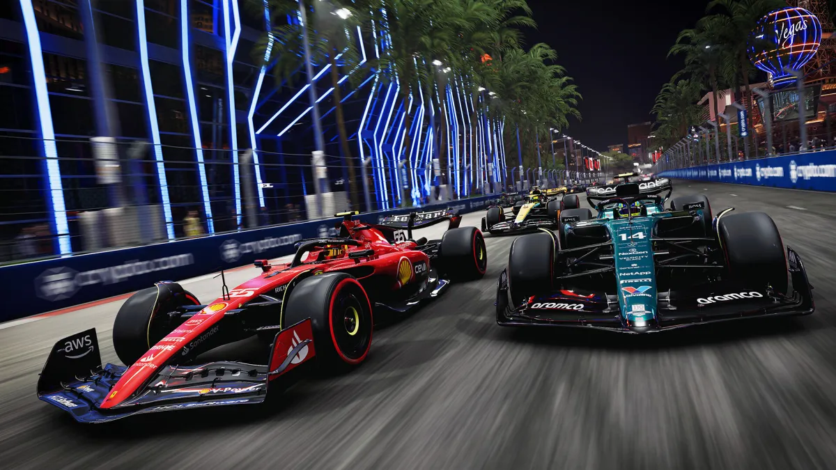 A Ferrari and Aston Martin F1 car racing down the Las Vegas strip.