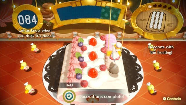 Princess Peach is decorating a giant cake