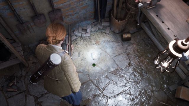 An Alone in the Dark screenshot that shows Emily looking at a plate piece of the ground of a musky basement.