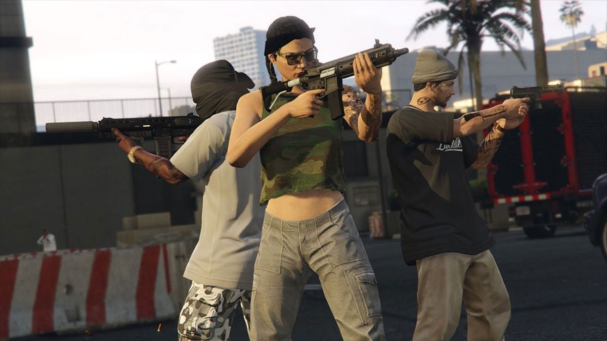 A crew in GTA Online hold up weapons outside of a facility in Los Santos.