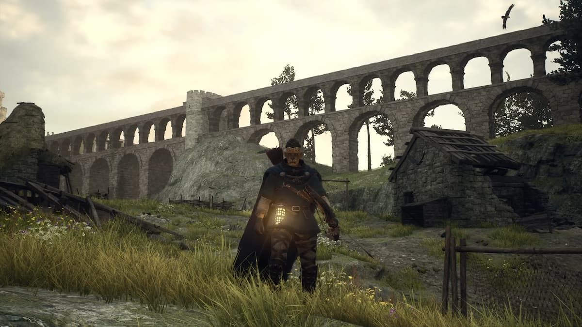 An Archer in Dragon's Dogma 2 stood in front of a viaduct.