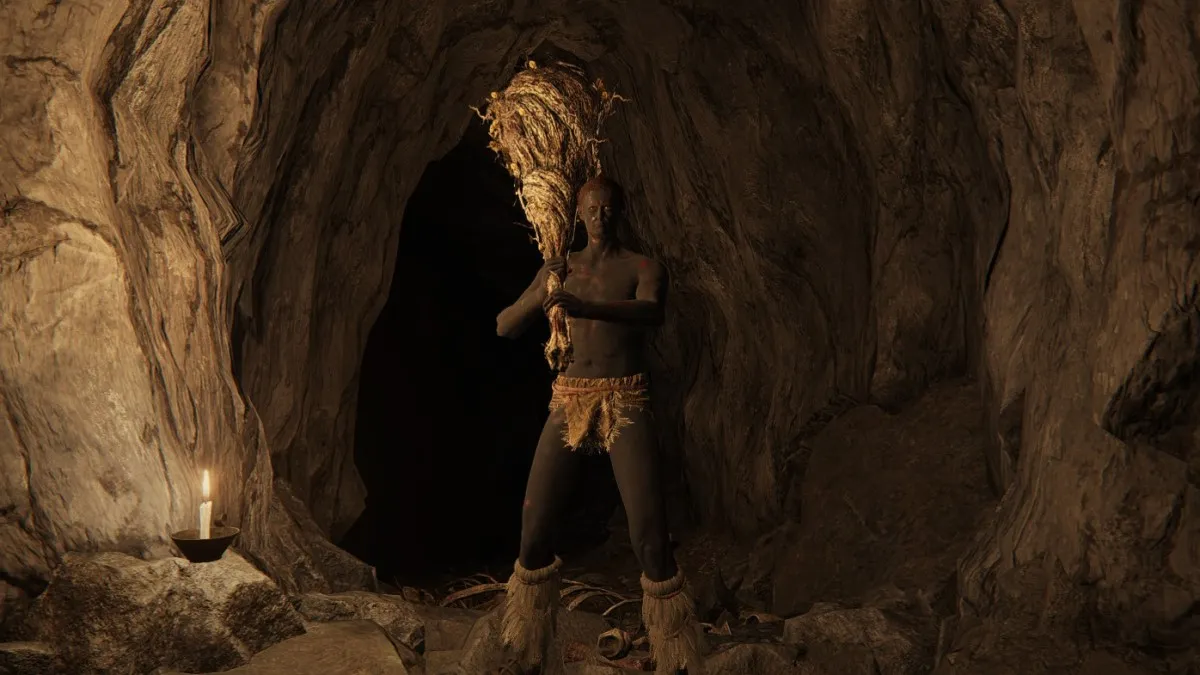 A tribal man holds a large stick in Elden Ring.
