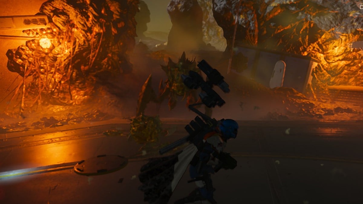 A Guard Dog, in Helldivers 2, reattaches to its backpack to reload as a large bug runs towards the Hell Diver.