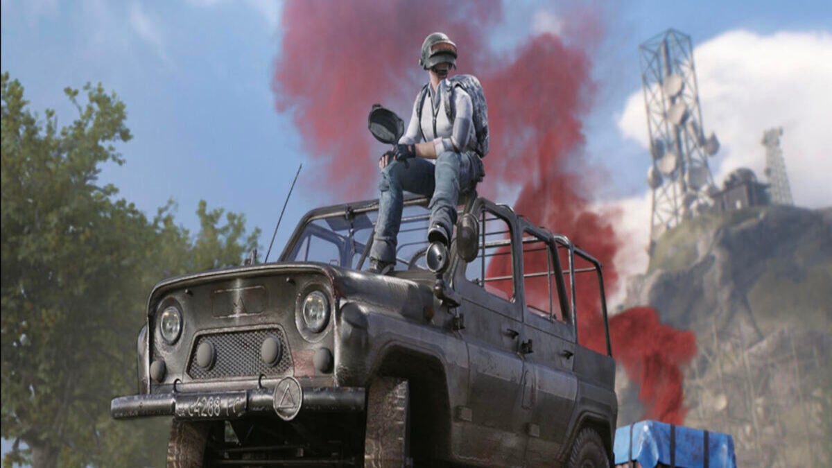 PUBG Mobile player sitting on an UAZ with an air drop behind