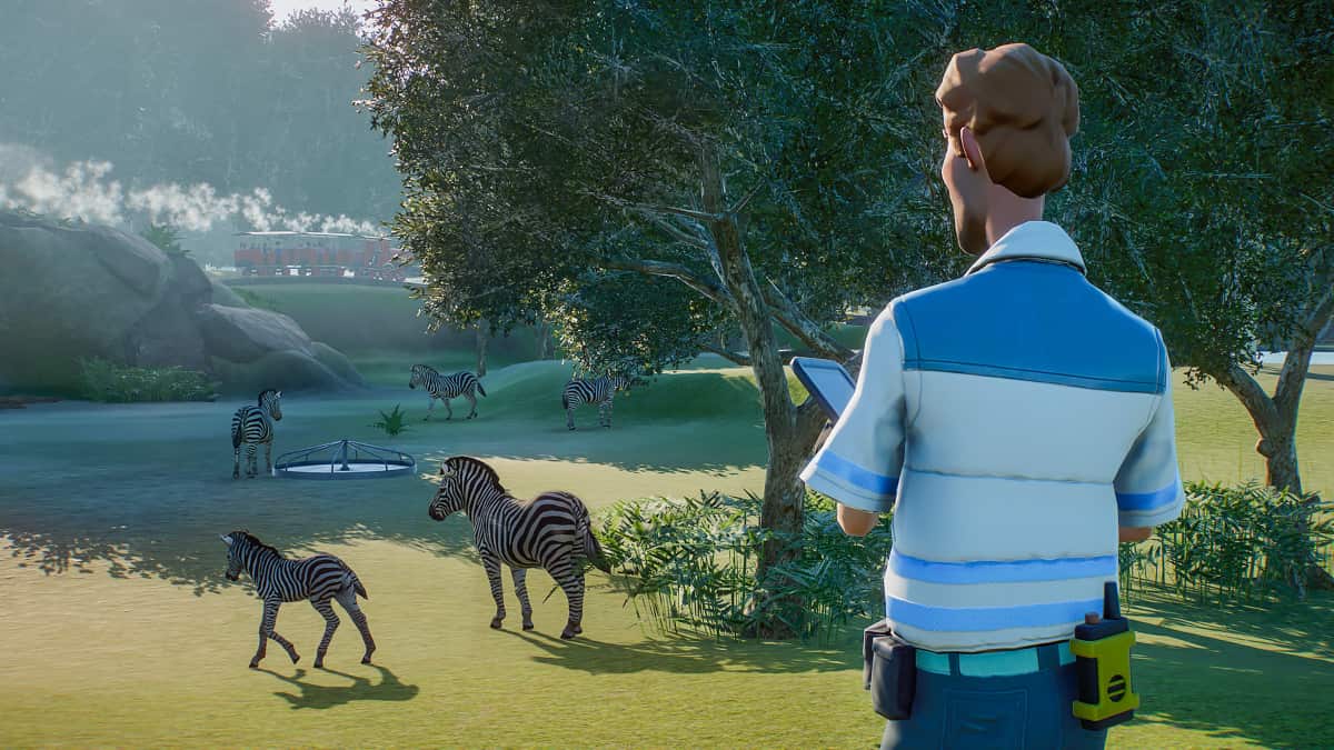 A zookeeper looking over a group of zebra in Planet Zoo.