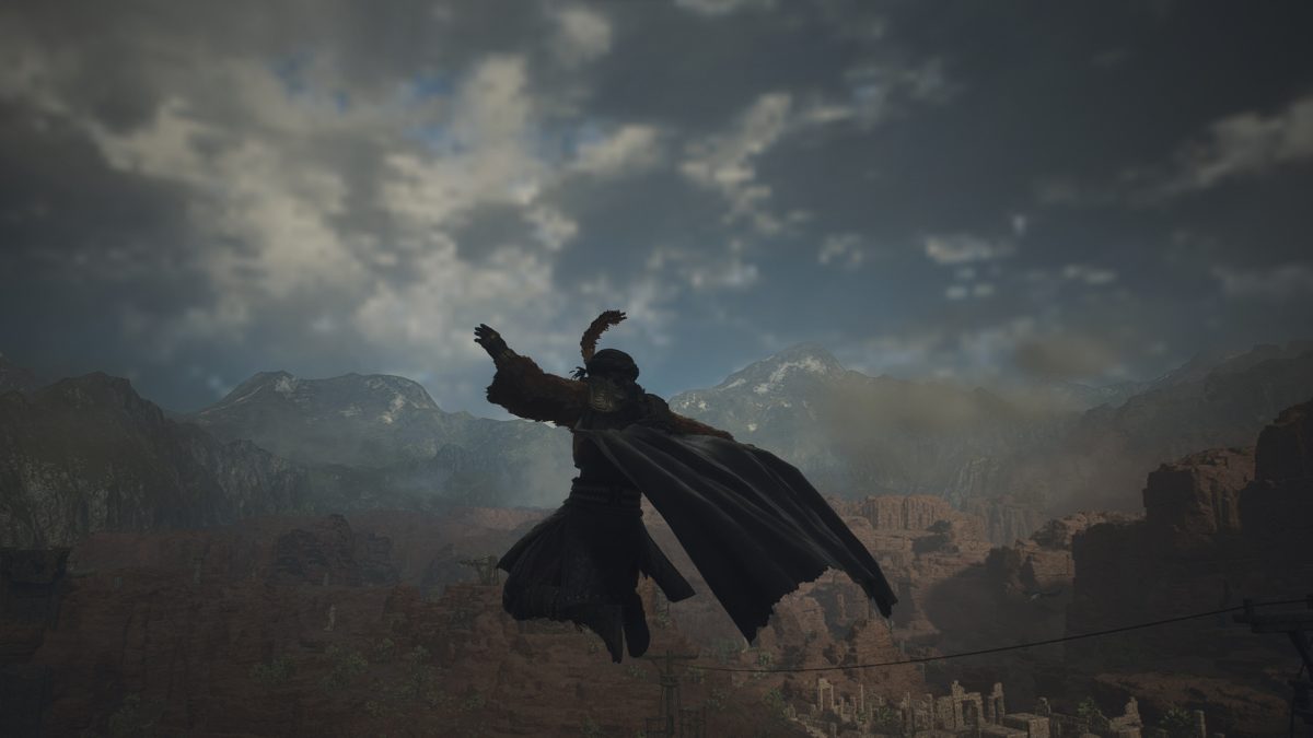 A Thief character in Dragon's Dogma 2 leaps through the air, cloak billowing behind them