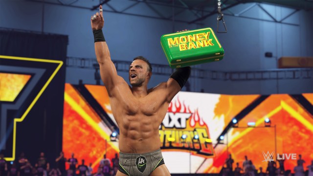 LA Knight holding the green Money in the Bank briefcase.