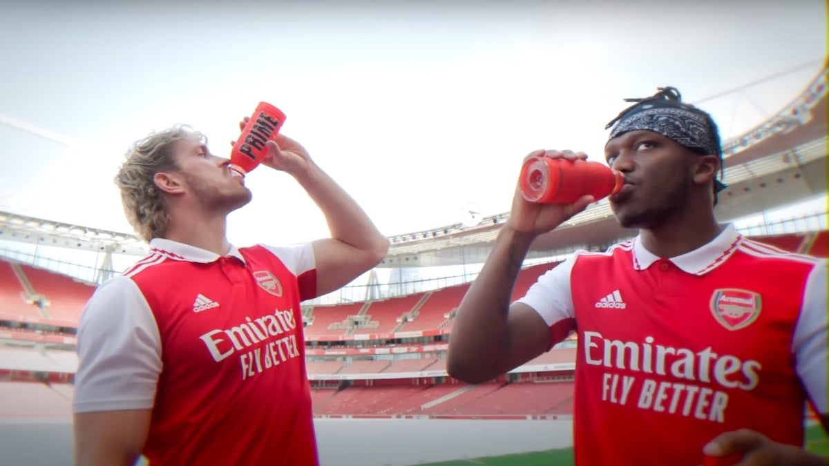 KSI and Logan Paul drinking Prime in Arsenal jerseys.