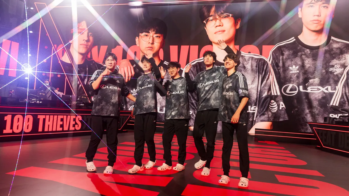 The 100T squad stand on stage celebrating a win in the LCS Spring Split.