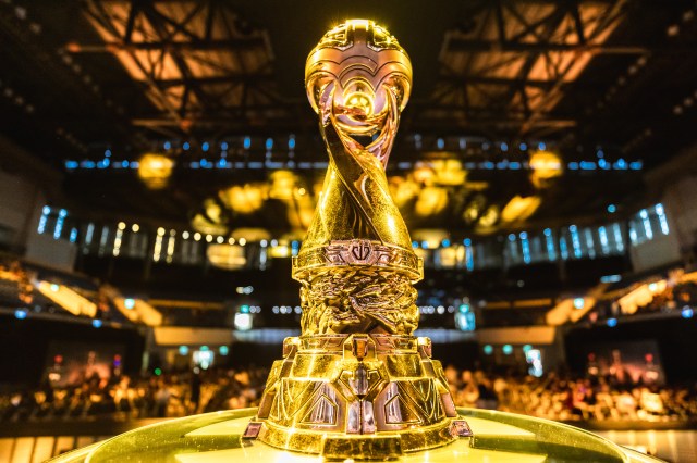 The golden MSI trophy, sitting on a plinth, infront of a packed arena.
