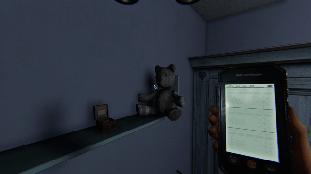 The Music Box Cursed Possessions next to teddy bear on a shelf in Phasmophobia.