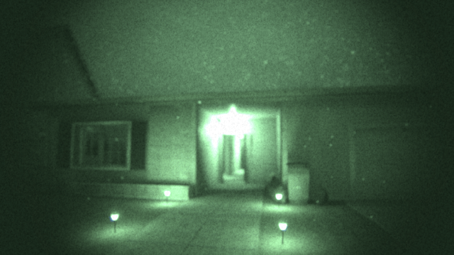 The player looking at 6 Tanglewood Drive through Night Vision Goggles in Phasmophobia.