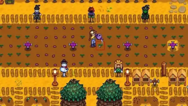 The player standing by many Sprinklers that just watered crops in Stardew Valley.