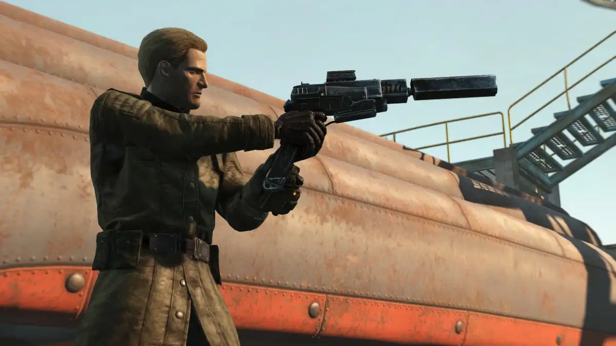 A character in Fallout 4 holding an Enclave pistol.