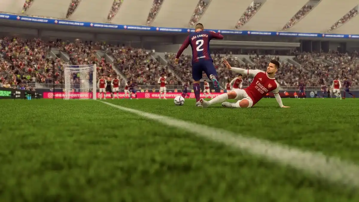 A defender slide tackles an attacker in EA FC 24.
