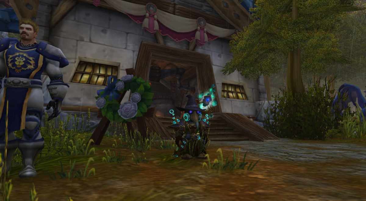 A gnome mage stands in front of the Blacksmith in Goldshire in World of Warcraft