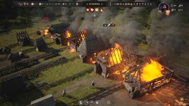 Village buildings getting burnt by bandits.