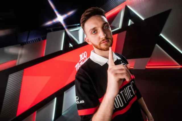 Closer wearing a 100T jersey, holding up one finger.