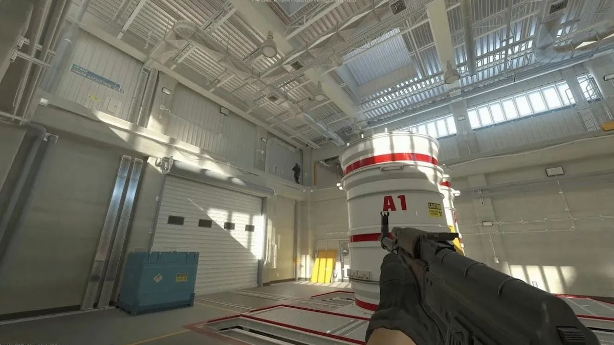 CS2 player holding AK and pointing at another player on Nuke's A bomb site