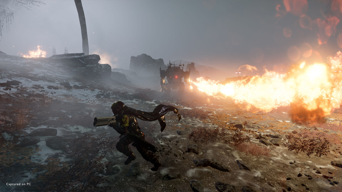 A Helldiver strafes away from a Hulk Automaton launching flames from a weapon in Helldivers 2.