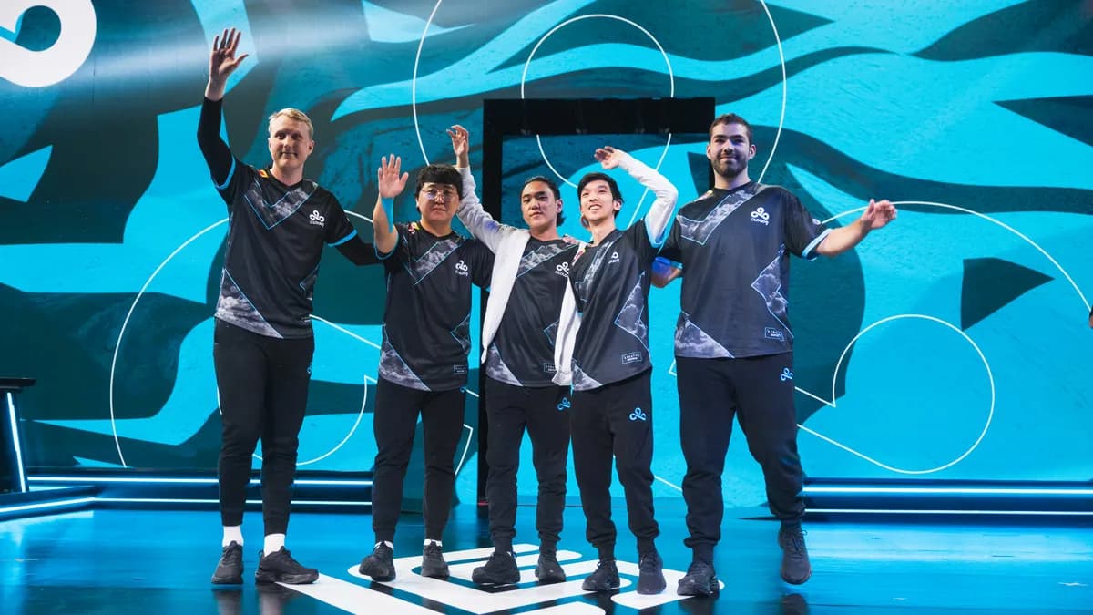 The Cloud9 League of Legends team stand victorious on stage in the LCS, waving to the crowd.