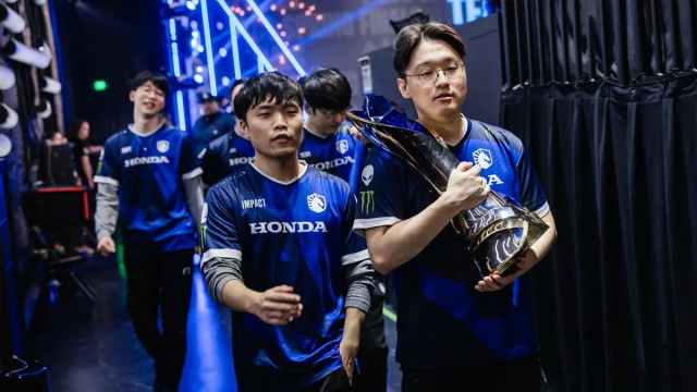 Impact and CoreJJ walk off stage with the LCS 2024 Spring Split trophy.
