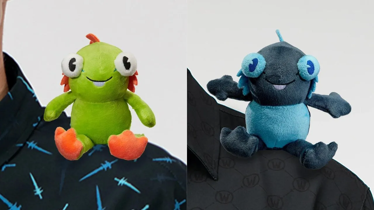 Mini murloc plushies in green and blue on a shoulder