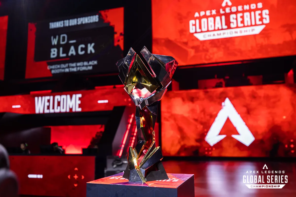 The ALGS trophy sits on stage. ALGS logos are spread across screens in the background.