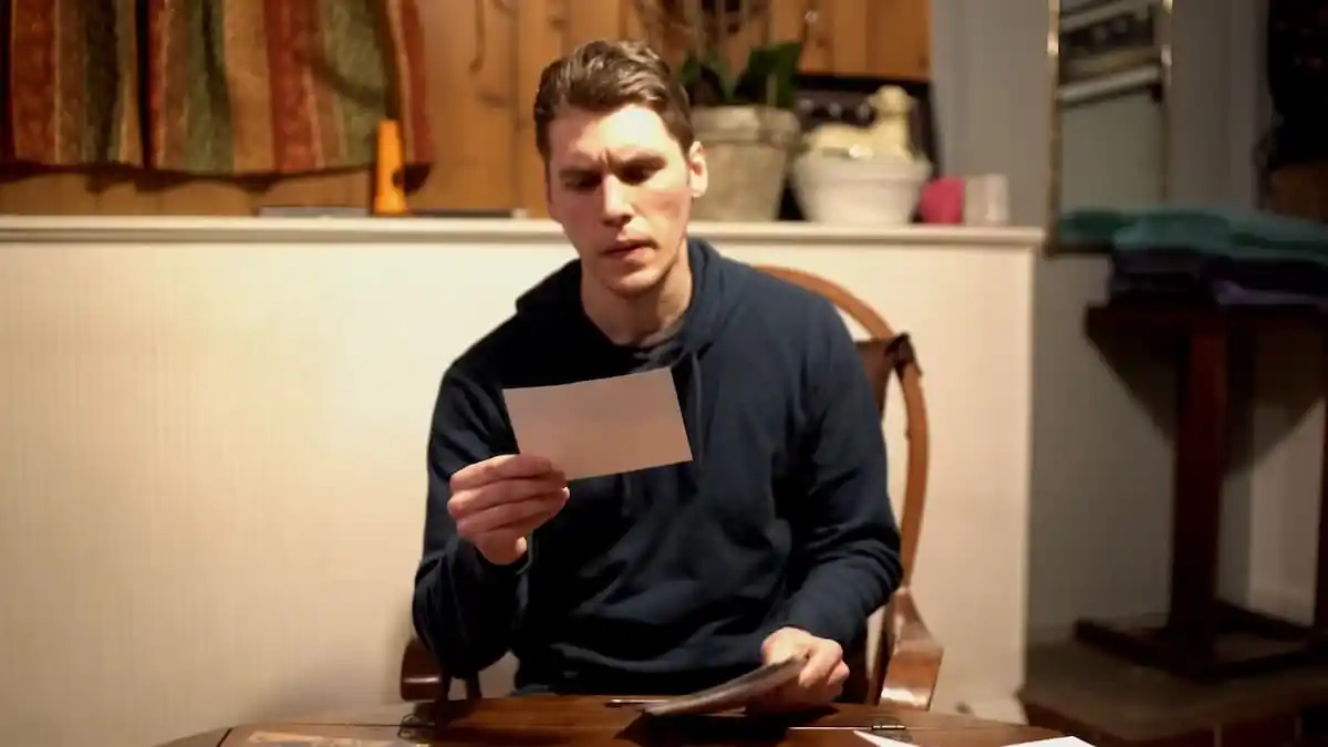 Popular streamer Jerma looking at photos while sitting in his house.