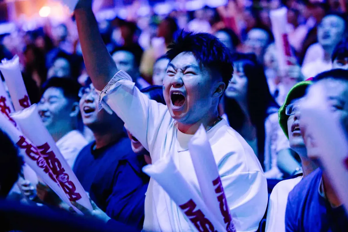 A fan cheers on the action in the crowd at MSI 2024