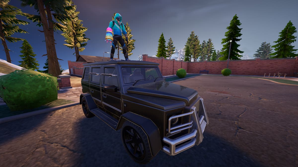 Player standing at the roof of the car in Fortnite.