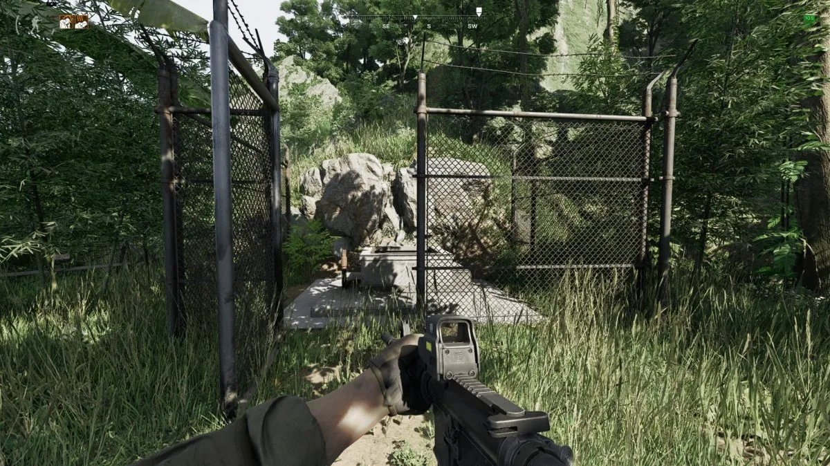 A hidden entrance to a bunker, surrounded by fences in the forest in Gray Zone Warfare.
