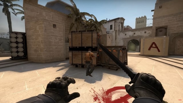 A CS2 player sneaking upon an enemy with a knife.