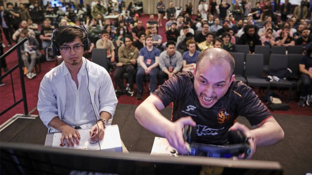 Two players sit and play in front of a live audience at BAM.