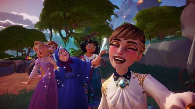 The player taking a picture with Mirabel, Anna, Rapunzel, and the Fairy Godmother in Disney Dreamlight Valley.