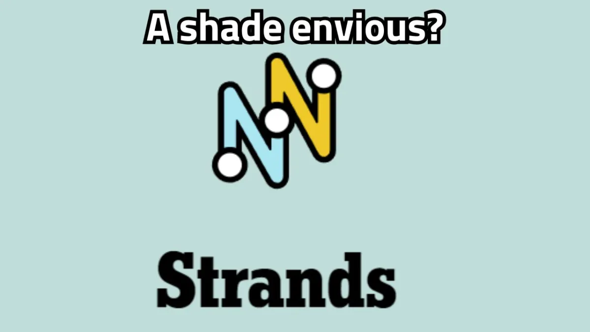 The NYT Strands logo with "A shade envious?" written on top of it.
