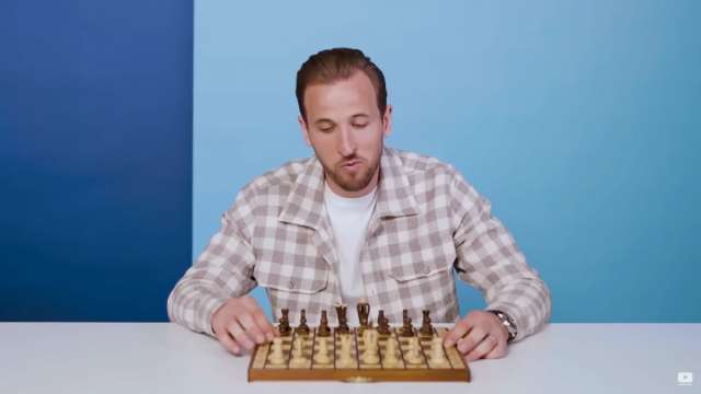 Harry Kane in front of a chessboard.