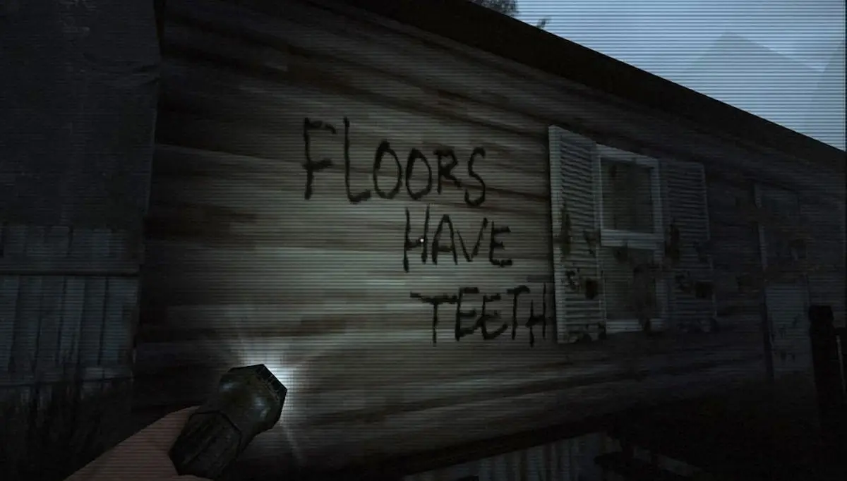 A flashlight is pointing at a sign that says Floors Have Teeth