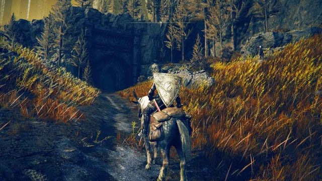 A character on horseback facing the entrance to Shadow Keep, Church District in Elden Ring DLC