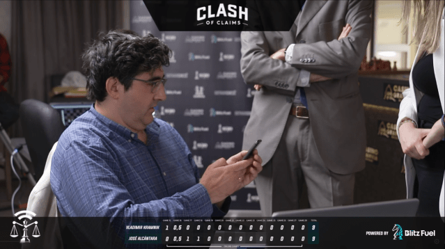 Vladimir Kramnik with a phone in his hand at the Clash of Claims match
