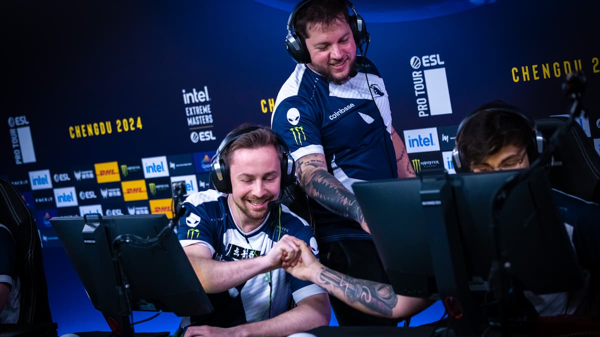 Cadian fist bumping Twistzzz with zews in the background.