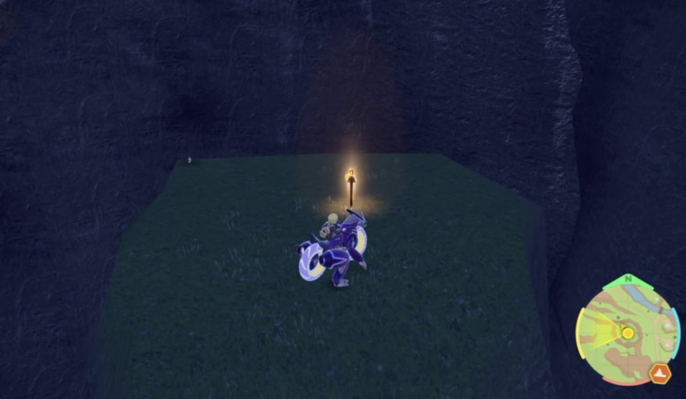 A player in Pokemon Scarlet and Violet riding on the back of Moraidon, staring at a yellow glowing stake in the ground.