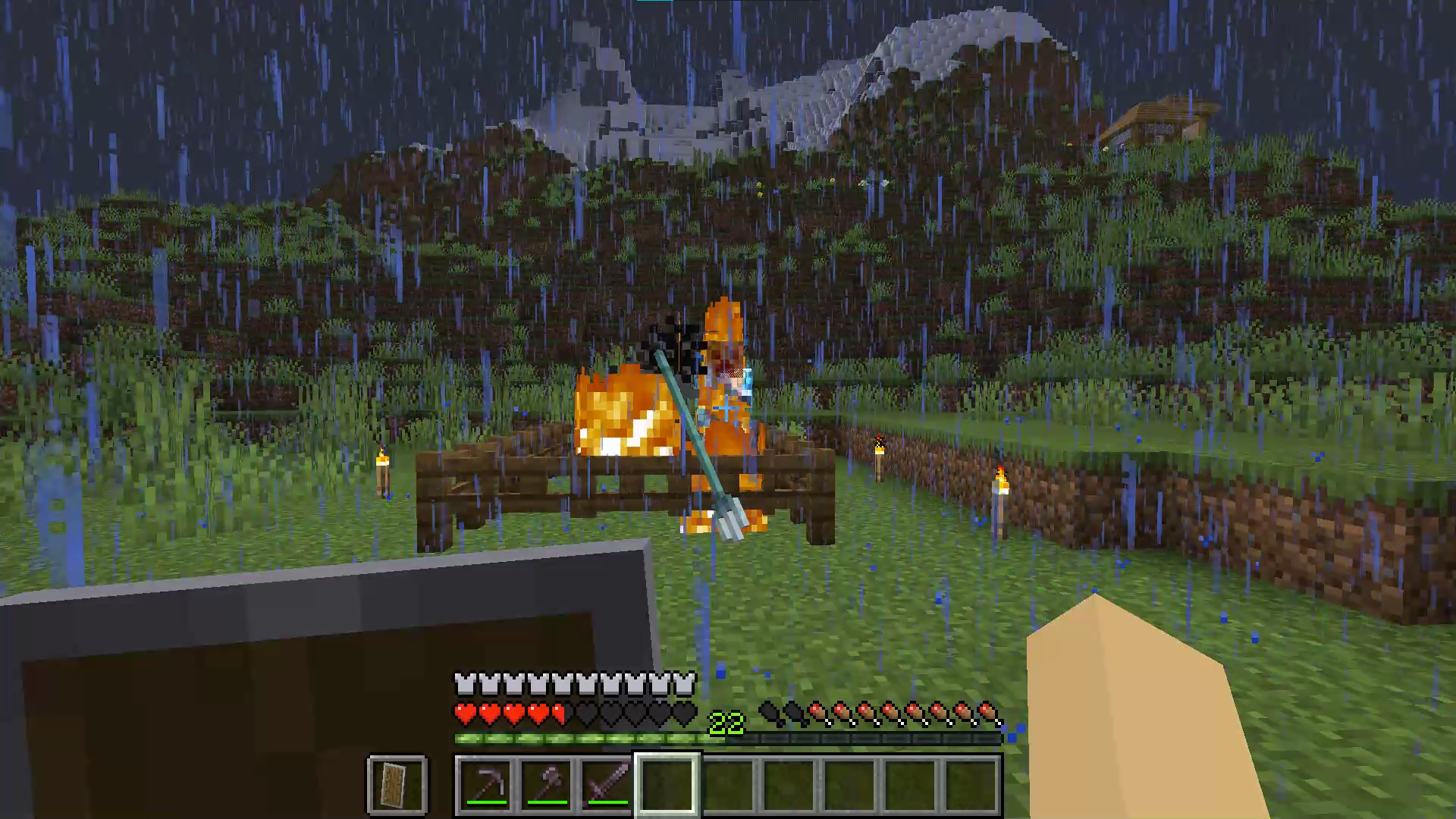 Image of a Charged Creeper on fire after being struck by lightning, enclosed within wooden fences in the game Minecraft