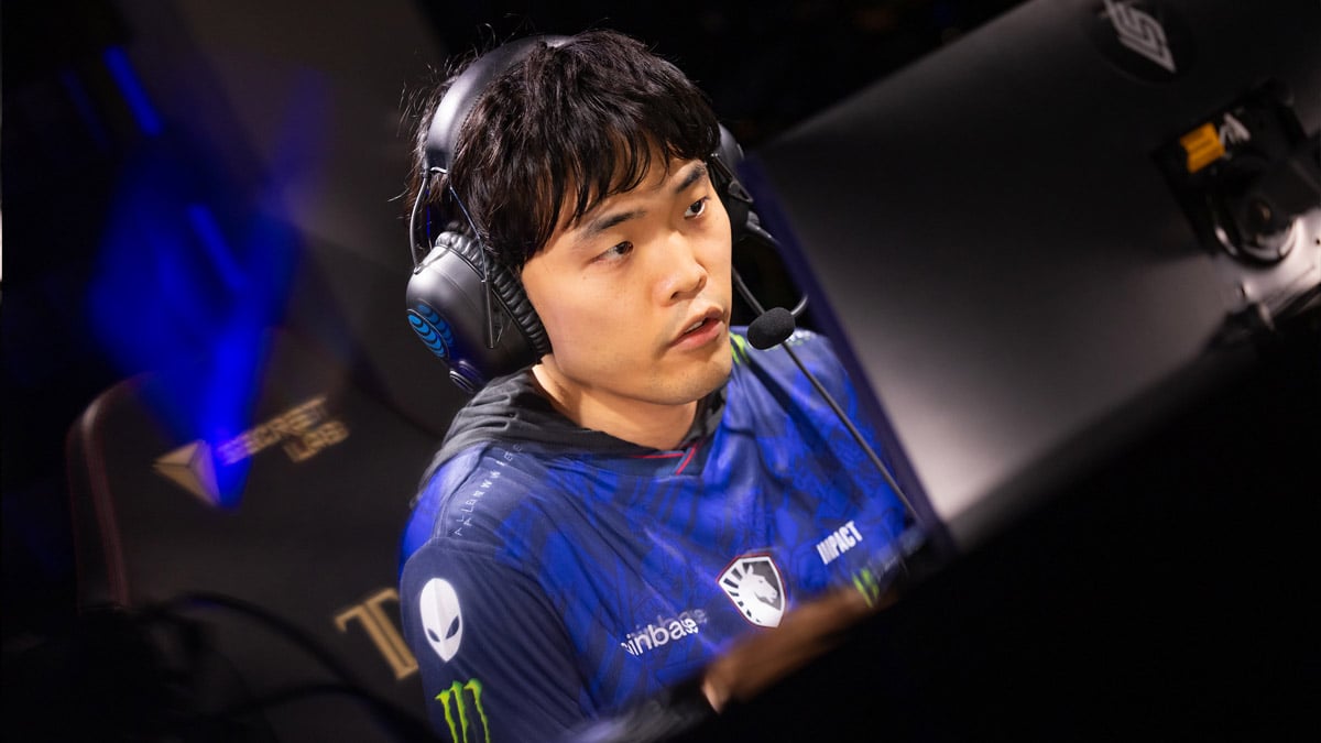 Impact sits at his PC playing League of Legends in the LCS.
