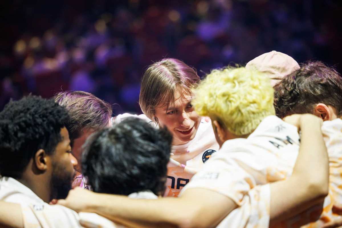 Fnatic huddle on stage at VALORANT Champions Seoul Playoffs Stage with player Chronicle at their center.