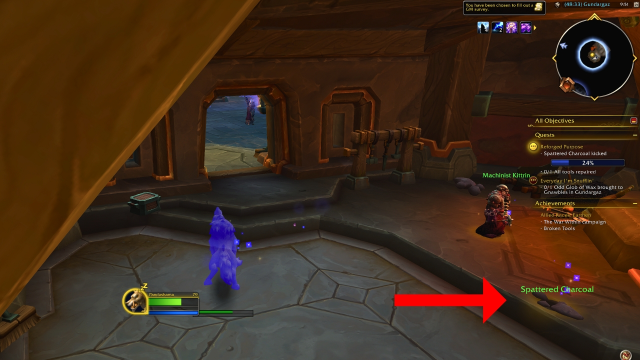 A red arrow pointing to spattered charcoals the player needs to pick up in wow the war within