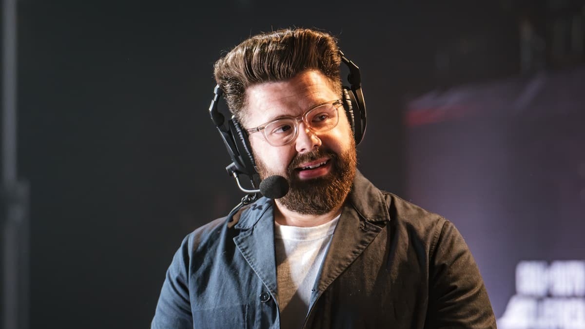 Miles Ross wearing a headset and looking to the side while commentating over a Call of Duty match.